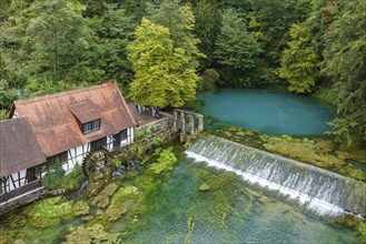 Blautopf Blaubeuren with industrial monument Hammerschmiede, source of the little river Blau in a