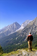 Hikers at the Staller Sattel, with Lake Antholz, behind Hochgall, between the Antholz Valley, South