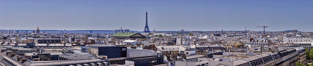 Wide city view with Eiffel Tower under a blue sky, Paris