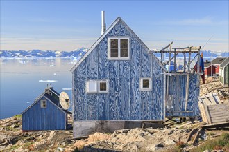 Typical Greenlandic house in an Inuit settlement on a fjord off Bergen, sunny, Ittoqqortoormiit,