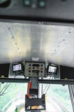 Screen system and control units on the ceiling of a modern control room, track construction Hermann