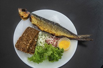 Traditional Bornholm dish: smoked fish, rye bread and vegetables in Gudhjem, Bornholm, Baltic Sea,