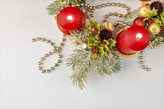 Festive Advent wreath with burning red candles, decorated for Christmas, from above, white