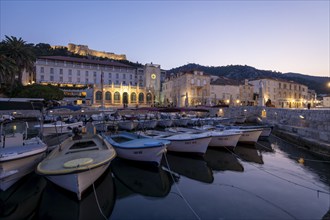 Illuminated harbour at sunrise with boats and historic buildings, Hvar, Croatia, Europe