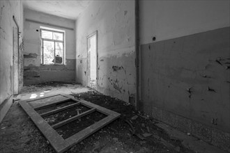 Dark, dilapidated corridor with broken window frame and rubble, Lost Place, Lastovo, Neretva,