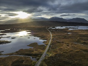 Morning light, cloudy mood, sunbeams, loch, mountain landscape, moor, aerial view, road, autumn,