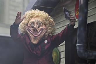 Person masked as Thomas Gottschalk at the carnival parade of the Wey guild on Rose Monday,