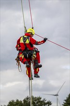 Height rescuers from the Gelsenkirchen fire brigade practise abseiling from a wind turbine from a