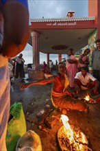 Hindu priest with pilgrims at the fire ritual at Ghat Agni Theertham, Rameswaram, Pamban Island,