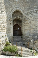 Billy. The entrance to a historic fortified castle, showcases medieval architecture from the 13th