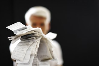 The subject of taxes. A man holds receipts in his hand in Berlin, 09/08/2024