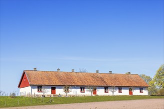 Old barn that has been converted into a residential building on a sunny spring day in the