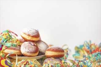 Colourful decoration and doughnuts, carnival table, copy room, white background