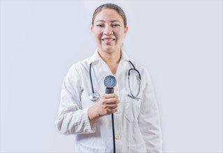 Young female doctor holding tensiometer on isolated background. Smiling female doctor showing blood