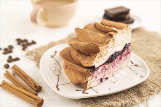 Zephyr or marshmallow cake with cup of coffee on white wooden background and linen textile. side