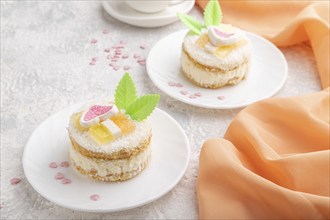 Decorated cake with milk and coconut cream with cup of coffee on a gray concrete background and