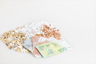 Various tablets and euro banknotes on top of each other, white background, copy room