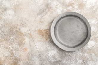 Empty gray ceramic plate on gray concrete background. Top view, copy space, flat lay