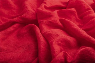 Fragment of red linen tissue. Side view, natural textile background and texture. wave concept,