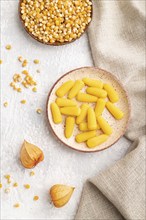 Jelly corn candies on gray concrete background and linen textile. top view, flat lay, close up