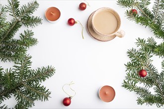 Christmas or New Year frame composition. Decorations, red balls, fir and spruce branches, cup of