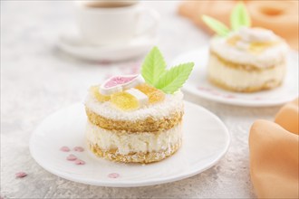 Decorated cake with milk and coconut cream with cup of coffee on a gray concrete background and