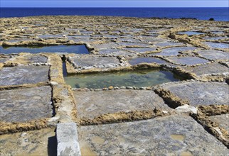 Historic ancient salt pans on coast near Marsalforn, island of Gozo, Malta, Europe