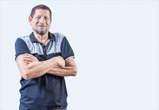 Portrait of smiling senior man with arms crossed isolated. Smiling latin old man with arms crossed,