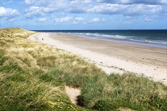 Wide sandy beach at Seahouses, Northumberland, England, UK