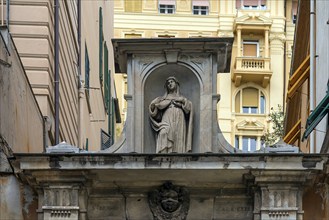 Sculpture of the Holy Madonna above an archway in the historic centre, Genoa, Italy, Europe