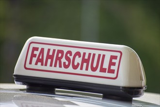 Close-up of a driving school sign in Germany