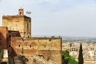 Watchtower with flags and tourists, Torre de la Vela, Alcazaba, Alhambra, Granada, Andalusia,