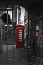 Old red phone booth in the courtyard