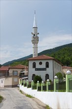 A whitewashed mosque with a minaret along a quiet street, Melivia, Melivoia, centre of the Pomaks,