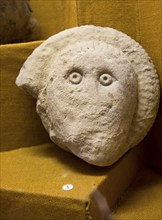 Human face carved onto an ammonite, using the natural form of the fossil. Found in Great Bedwyn.