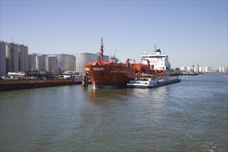 Chemical oil bulk carrier ship 'Crystal Topaz' next to storage tanks, Port of Rotterdam,