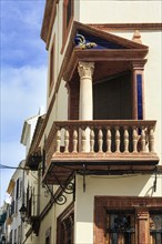 Decorated wooden balcony, corner balcony, façade detail in the historic centre, Priego de Cordoba,