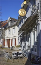 Outdoor area of the Vollmond pub and old residential buildings on Rathausplatz square in the