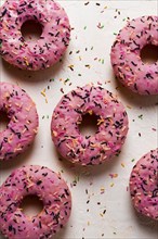 Donut with strawberries, in pink glaze, confectionery decoration, top view