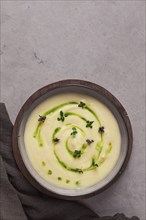 Mashed potatoes, with green butter and micro greenery, homemade, on a beige table, no people, top