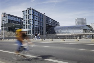 A cyclist rides in front of Berlin Central Station in Berlin, 27/03/2024