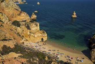 Rocky coast with beach and red rocks, Praia do Camilo, Lagos, Algarve, Portugal, Europe