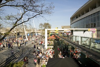 Crowds of people on the South Bank in front of the Royal Festival Hall, London