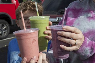 Wheat Ridge, Colorado, Customers display the smoothies they purchased at the Twisted Smoothie