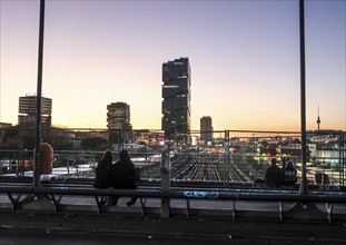 Chilling out at sunset on the Modersohn Bridge, view of railway tracks, trains and the 140 metre