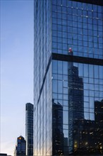 Glass surface facade mirroring an iconic skyline in evening light, AI generated