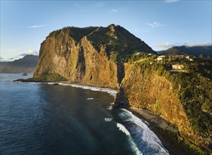 Aerial view of Madeira cliffs coastline landscape on sunrise, Guindaste viewpoint, Madeira island,