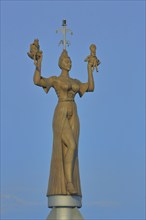 Sculpture Imperia by Peter Lenk 1993, figures, woman in outstretched arms holding two figures,