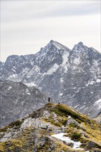 Mountaineer in front of mountain panorama on the ridge of Hahnkampl, mountain panorama with rocky