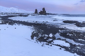 Rocks and surf on the coast, evening light, sun, snow, winter, Arnarstapi, Snaefellsnes,